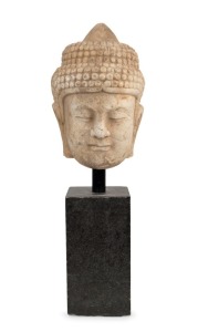 An antique Chinese carved marble Buddha head, late Ming Dynasty, 16th17th century, later stand, the head 32cm high