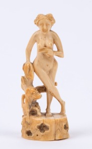 An antique carved ivory statue of a standing female nude with dog, 19th century, 9cm high