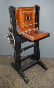 Vintage large format studio camera, with mahogany body, rack focusing, leather bellows. (no lens present). 150cm high. Maker unknown, but ivorine plate present on one upright.