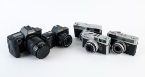 CANON cameras, comprising a Canon Coronet Junior [#152460]; a Bell & Howell/Canonet 19 [#678756]; a Canondate E [#215893]; a Canon T70 marked for "U.S.Navy" use [#1715708] and a Canon EOS630 [#2198946] with 35-105mm tele-photo lens. (5 cameras).