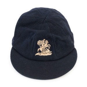 GRAHAM MCKENZIE COLLECTION - 1962-63 ASHES SERIES: English Cricket Cap in deep blue with embroidered 'George & Dragon' on front worn by wicket-keeper Alan (A.C.) Smith during the series and exchanged with Graham McKenzie. The names of both cricketers are on the underside of the cap.
