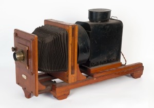 Thornton-Pickard: Enlarger, painted tin and mahogany bearing ivorine plaque "Thornton-Pickard Artist Enlarger, Altringham", with original lens by Taylor, Taylor & Hobson [#18269],45cm high, 80cm long