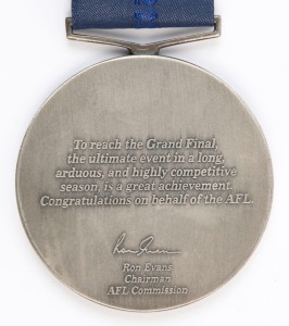 JAMES HIRD'S RUNNERS-UP MEDAL, from the 2001 Grand Final; the medal showing two players with the MCG in the background, and text "AFL Grand Final, 2001, Runners-up/ AFL". Reverse has text, "To reach the Grand Final, the ultimate event in a long, arduous, and highly competitive season, is a great achievement. Congratulations on behalf of the AFL. Ron Evans, Chairman, AFL Commission". The medal is suspended from the original 2001 Grand Final sash and is accompanied by the box.