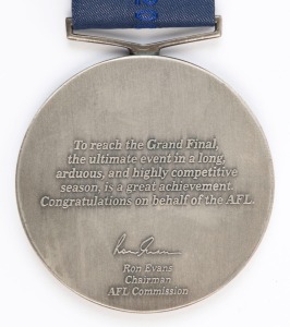 JAMES HIRD'S RUNNERS-UP MEDAL, from the 2001 Grand Final; the medal showing two players with the MCG in the background, and text "AFL Grand Final, 2001, Runners-up/ AFL". Reverse has text, "To reach the Grand Final, the ultimate event in a long, arduous, 