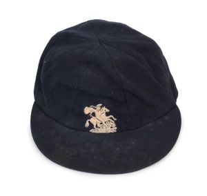 GRAHAM MCKENZIE COLLECTION - 1965-66 ASHES SERIES IN AUSTRALIA: English Cricket Cap in deep blue with embroidered 'St George and the Dragon' on the front, worn by English fast bowler Jeff Jones during the series and exchanged with Graham McKenzie. The name "I.J.Jones" is hand-written on the Simpson of Piccadilly maker's label; good condition overall. Jeff Jones took 6 for 118 in the Fourth Test and was England's top wicket taker for the series with 15 scalps.