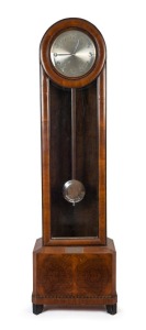 Presentation longcase clock with sterling silver plaque affixed: "PRESENTED TO J. CRAWFORD, ESQ. BY HIS FELLOW MEMBERS OF The N.S.W. Lawn Tennis Ground IN HONOUR OF HIS 1933 VICTORIES : WIMBLEDON : FRANCE : AUSTRALIA : DAVIS CUP". The clock is housed in an art deco walnut veneered case with ebonised moldings housing a 3-train quarter chiming weight-driven movement with original weights and pendulum; eight-day duration; circa 1930.