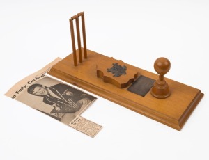GRAHAM MCKENZIE COLLECTION - 1968 CRICKETER OF THE YEAR: wooden 'Golden Peanut Award - Australia's Cricketer of Year' trophy presented to Graham McKenzie by Sir Alan Mansfield (Governor of Queensland) on behalf of the Peanut Marketing Board at Brisbane on March 20, 1968; length 40cm, width 17cm; also a 1968 (Mar.23) newspaper cutting from 'The West Australian' showing McKenzie holding the trophy, and wearing the presentation blazer (see previous lot).
