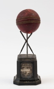 GRAHAM MCKENZIE COLLECTION - 1969-1975 LEICESTERSHIRE COUNTY CRICKET: Cricket ball used by Graham McKenzie to take 7 wickets for 8 runs in the first innings of a County Cricket match against Glamorgan in 1971, McKenzie finishing with match figures on 11 for 37, also contributing an undefeated 53 with the bat. The ball is detached from its presentation plinth.