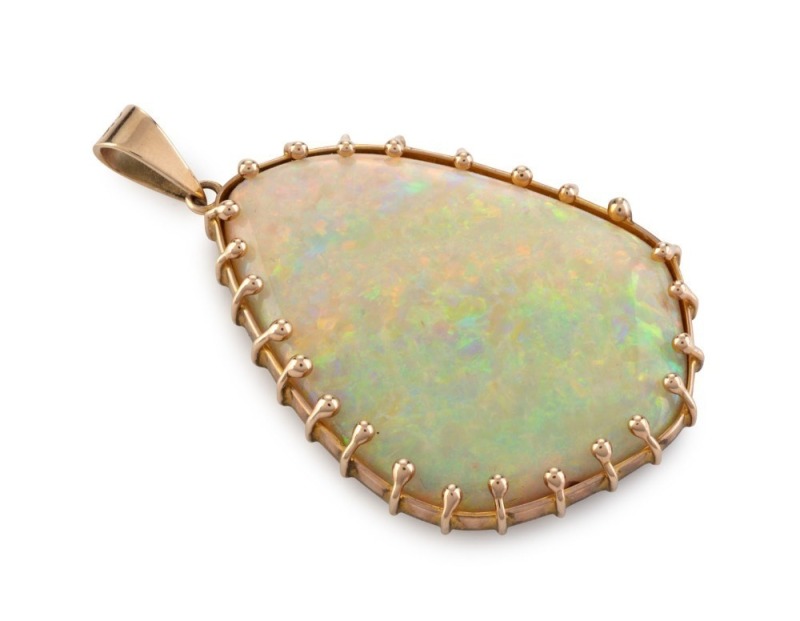 A stunning 30ct natural solid boulder opal pendant set in 9ct yellow gold mount, circa 1970s, 5cm high overall, 15.3 grams total. Accompanied by an Opal Gallery of Melbourne valuation for $15,850