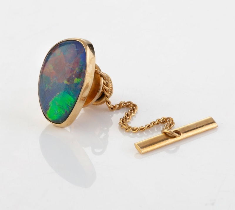 A 9ct yellow gold and opal triplet tie pin, circa 1970, 1.2cm wide. Accompanied by an Opal Gallery of Melbourne valuation for $1,220 