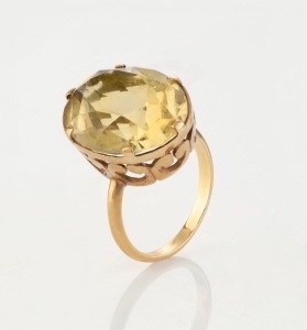 A yellow gold ring set with a large yellow topaz, 20th century, marks rubbed, 6.2 grams total