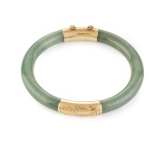 A Chinese jade bangle with 14ct yellow gold mounts, 20th century, ​​​​​​​7cm diameter