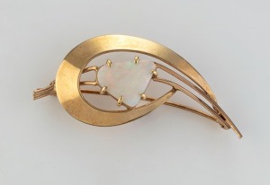 A vintage 9ct yellow gold brooch set with a solid opal, circa 1970, stamped "9ct", 5cm wide, 4.4 grams