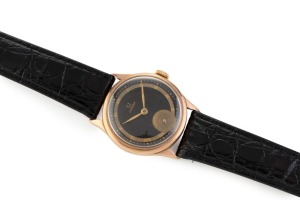 OMEGA boys size rose gold cased manual wristwatch with Roman numerals, subsidiary dial and black face, 3cm wide including crown