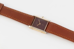 CARTIER gold plated dress watch with quartz movement, sapphire crown and burgundy face, 2.5cm wide across the crown