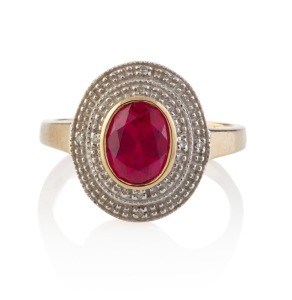 A 9ct yellow gold ring set with red stone in white gold oval mount studded with diamonds, stamped "375", 3.7 grams
