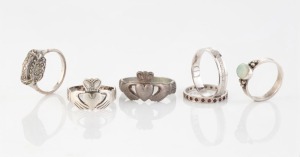 An 18ct white gold wedding band (3.5 grams), two antique sterling silver Claddagh rings, an opal and silver ring, a garnet and silver eternity ring, and a silver and marcasite ring, 19th and 20th century, (6 items),