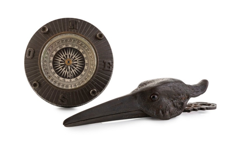 An antique bronze paperweight with inset compass; together with a bird's head document clip, 19th century, 8cm diameter and 15cm long