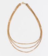 A three strand yellow gold necklace set with Baroque natural pearls, tests as 15ct gold, 43cm long, 16 grams total