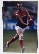 MELBOURNE - PLAYER SIGNED COLOUR PRINTS:&nbsp;action images (46x31) of&nbsp; Aaron Davey, Cameron Bruce and Jack Watts; also a copy of artwork by Paul Harvey showing Ron Barassi, boldly signed by the Demons legend.&nbsp;(4 items) - 3