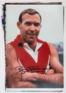 AFL/VFL - PLAYER SIGNED COLOUR PRINTS: mostly action images (46x31cm) of Bobby Skilton (South Melbourne), Paul Roos (Sydney Swans coach, image showing him raising the 2005 AFL Premiership Cup), Warren Tredrea (Port Adelaide), Alistair Lynch (Brisbane, image showing him sat in changing rooms alongside Premiership Cup after 2002 GF win), Robert Harvey, 'Boomer' Harvey (North Melbourne); also smaller images of Glenn Archer (North Melbourne), Cyril Rioli (Hawthorn), John Nicholls (Carlton)
