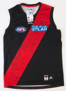 ESSENDON: Adidas guernsey (size M) with numerous signatures from the 2014 squad including Mark Thompson (coach), Jobe Watson (Capt.), Brendon Goddard, Paul Chapman, Michael Hurley and Dyson Heppell.