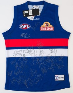 WESTERN BULLDOGS: KooGa guernsey (size L) with approximately 40 signatures from the 2011 squad including Robert Murphy, Mitch Wallis, Daniel Cross, Easton Wood, Adam Cooney & Tom Liberatore,