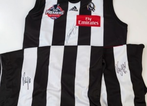 COLLINGWOOD: 2010 Premiership Guernseys (2, Size L & XL), the former signed by Dane Swan, the latter by Dayne Beams; also 2010 Premiers gold logo guernsey (size L) signed by Scott Pendlebury. (3)
