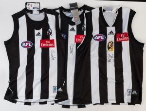 COLLINGWOOD: Adidas 2002 guernsey (size XL) signed by Nathan Buckley (2002 AFL Buckley trading card attached); also Adidas 2010 guernseys (Premiership Year) signed by Alan Didak (size S) or by Dale Thomas (size L). (3)