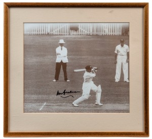 DON BRADMAN: sepia toned image (24x28cm) of "The Don" at the wicket strokemaking, boldly SIGNED BY BRADMAN in black marker pen; framed & glazed overall 36x38cm.