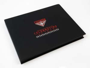 ESSENDON - LITERATURE: "Celebrating 140 Years", limited edition hardbound booklet album, 5 of the pages personally signed by David Evans, James Hird, Matthew Lloyd, Simon Madden & Jobe Watson; numbered #147 of only 250 produced, Retail $250+.