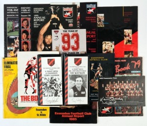 ESSENDON: Selection of items including 1993 Premiership Team image (20x13cm) signed by Kevin Sheedy in silver texter, 'Champions of Essendon' poster (tape repaired splits) signed by Terry Daniher & Kevin Sheedy; also literature with 1969 'The Bombers History Book', 1973 'Elimination Final' Football Record (Essendon v St Kilda) 1979 Year Book, Annual Reports for 1980-1983, 1985 & 1991, etc. (13 items)