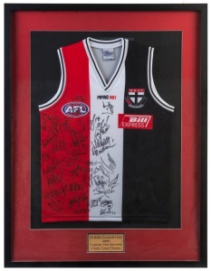 ST KILDA: display featuring jersey signed by members of the 2005 squad captained by Nick Riewoldt and coached by Grant Thomas with numerous signatures including Riewoldt, Stephen Milne, Fraser Gehrig, Nick Dal Santo & Lenny Hayes; framed & glazed, overall 102x78cm.
