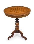 An antique walnut circular games table with chess and gaming pieces, 19th century, 74cm high 60cm diameter