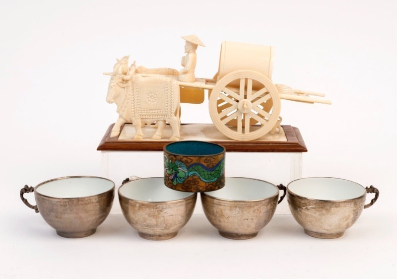 A Chinese carved bone and ivory cart ornament, an antique cloisonne napkin ring and a set of four silver and porcelain teacups, (6 items), the cart 18cm long 