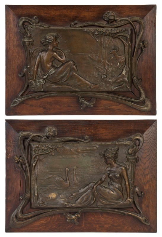 A pair of French Art Nouveau spelter wall plaques mounted on oak panels, circa 1895, 29 x 39cm each overall