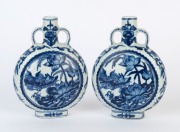 A pair of Chinese blue and white porcelain moon flask vases adorned with Mandarin ducks and lotus flowers, Republic Period, 20th century, six character underglaze blue Kangxi marks, 16cm high