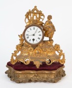 An antique French figural gilt metal clock, timepiece only with enamel dial and Roman numerals, together with a fine gilded stand with plush velvet top, 19th century, 34cm high overall