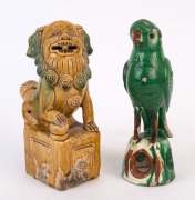 An antique Chinese pottery lion statue together with a green parrot statue, Ming and Qing Dynasties, 21cm and 22cm high