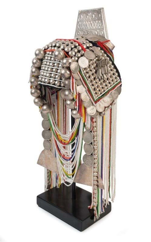 AKHA LOHMI HEADDRESS: Made from Indian Rupees, "Fat Man Dollars", French Indochinese Piastre coins, 20th century Burmese beads, hand-made silver moon-shaped buttons, chains, pendants, tassels, red-dyed chicken hackles and horse hair, circa 1950s.