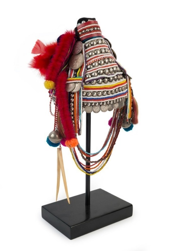 AKHA "U-LO" HEADDRESS: Made from Indian Rupees, French Indochinese coins, 20th century Burmese beads, hand-made silver moon-shaped buttons, pendants, tassels, red-dyed chicken hackles, horse hair, animal bone and wool, circa 1950s. 45cm high, 830 grams to