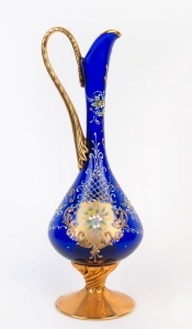 An Italian Murano blue glass ewer with gilt highlights and enamel floral overlay, 20th century, 36cm high