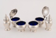 MAPPIN & WEBB six piece sterling silver condiment set with original blue glass liners, 20th century, the pepper pots 7.5cm high, 160 grams silver weight