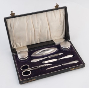 An antique sterling silver manicure set in original plush fitted box, early 20th century, ​​​​​​​the box 20.5cm wide