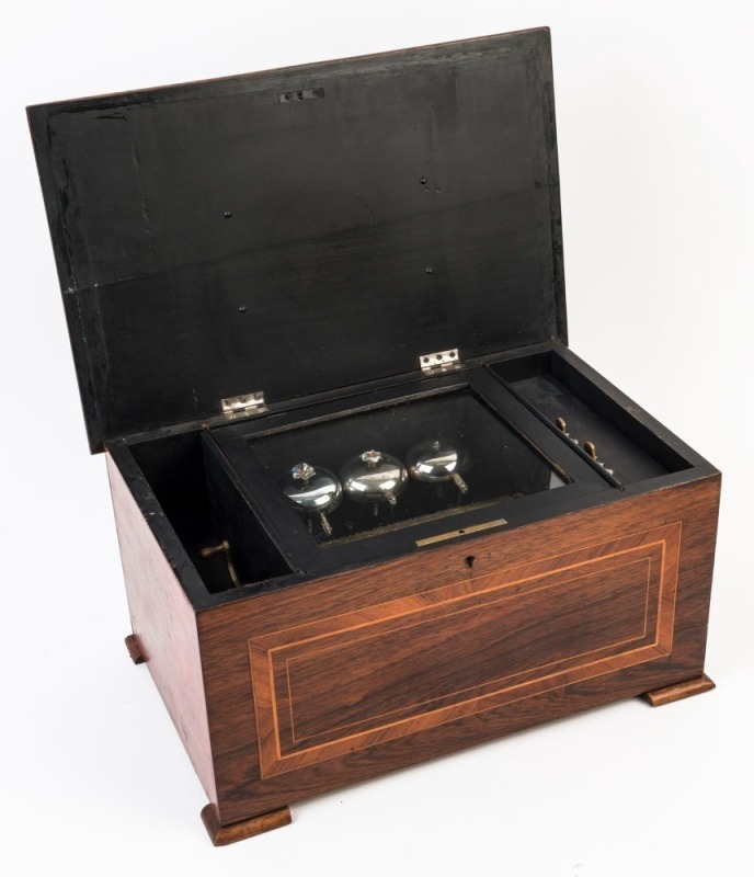 An antique music box in walnut case, 19th century, a 16cm cylinder with three bells, 22cm high, 42cm wide, 27cm deep