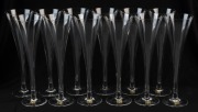 A set of twelve Continental glass champagne flutes, 20th century, 23cm high