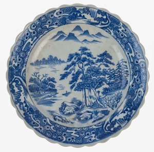 An antique Japanese porcelain charger with underglaze blue landscape scene, Meiji period, 19th century, impressed seal mark to base, 40cm diameter