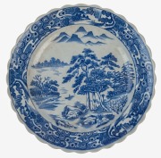 An antique Japanese porcelain charger with underglaze blue landscape scene, Meiji period, 19th century, ​​​​​​​impressed seal mark to base, 40cm diameter