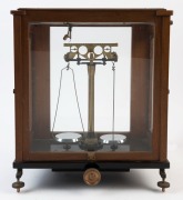 A set of scientific balance scales in timber and glass case, early 20th century, ​​​​​​​45cm high, 41cm wide, 25cm deep