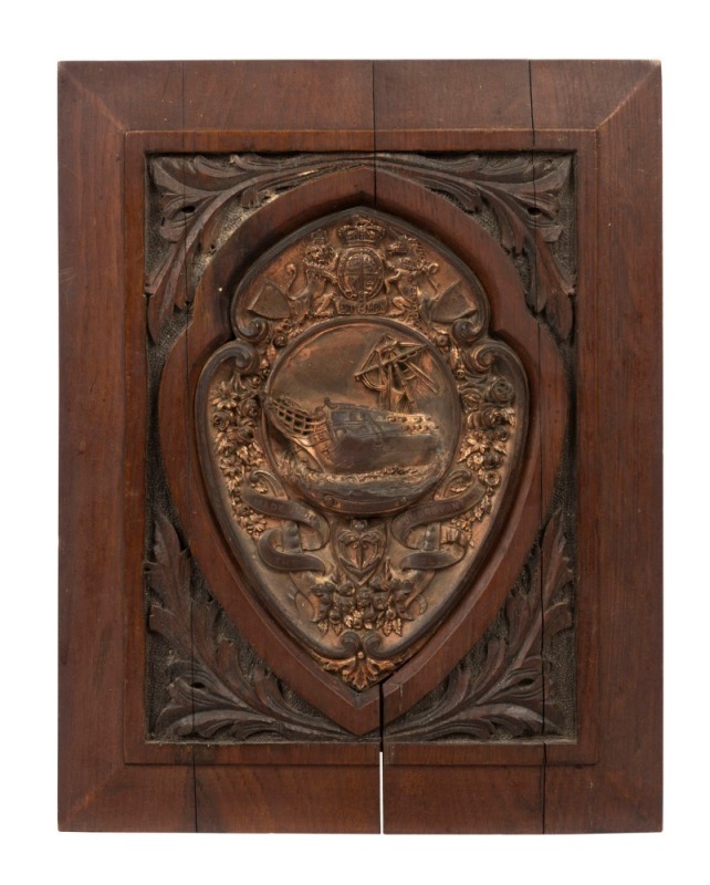 H.M.S. FOUDROYANT - NELSON'S FLAGSHIP: repousse copper plaque (copper sourced from the ship) showing an image of the wrecked ship within floral sprays beneath the British Royal crest, mounted on a teak board (also from the ship) with leaf motifs within th